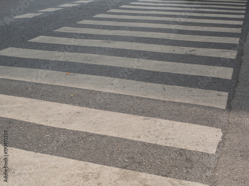 Zebra cross walk on asphalt road.