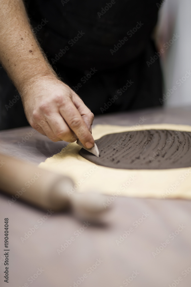 Fototapeta premium Skilled master preparing clay workpieces for new his creations