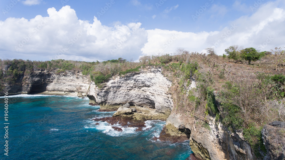 Seascape, rocky coast, ocean, blue sea, waves, Nusa Penida, Indonesia. Aerial view Ocean with waves and rocky cliff. Travel concept
