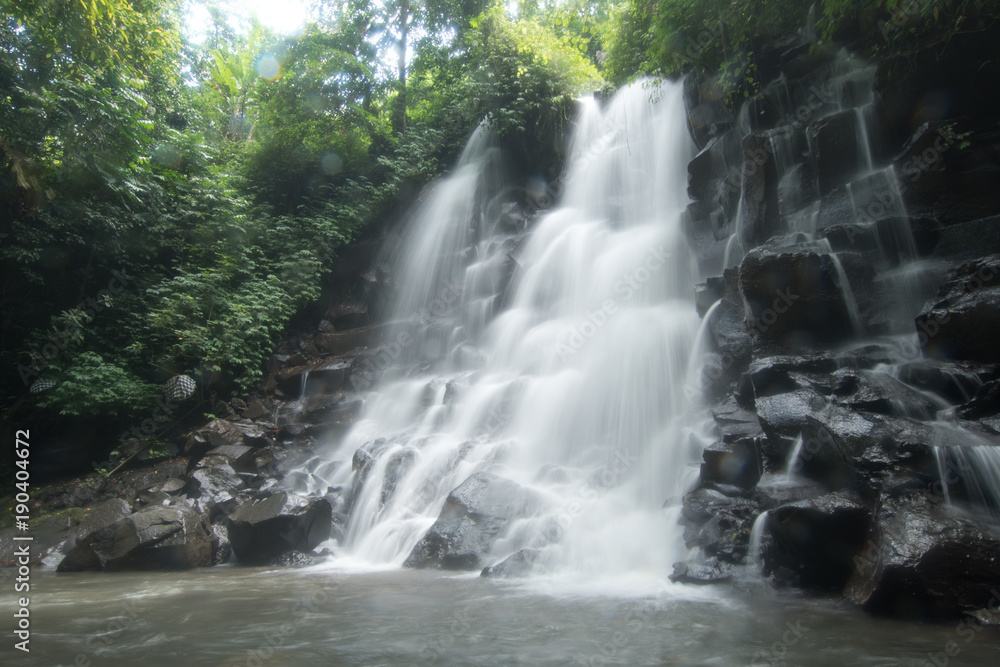 Obraz premium Waterfall in green rainforest. Triple waterfall Sekumpul in the mountain jungle. Bali,Indonesia. Travel concept.