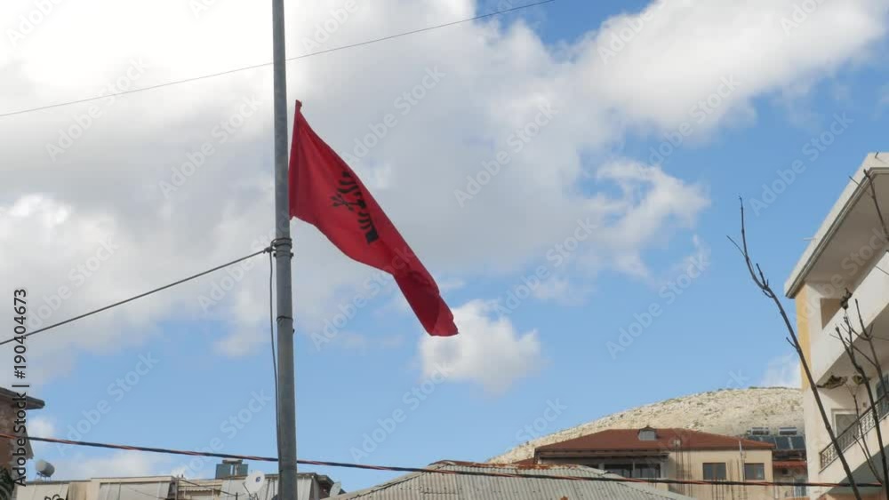 Albania, Saranda. Flag of Albania on flagpole