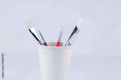 paint brushes in a cup