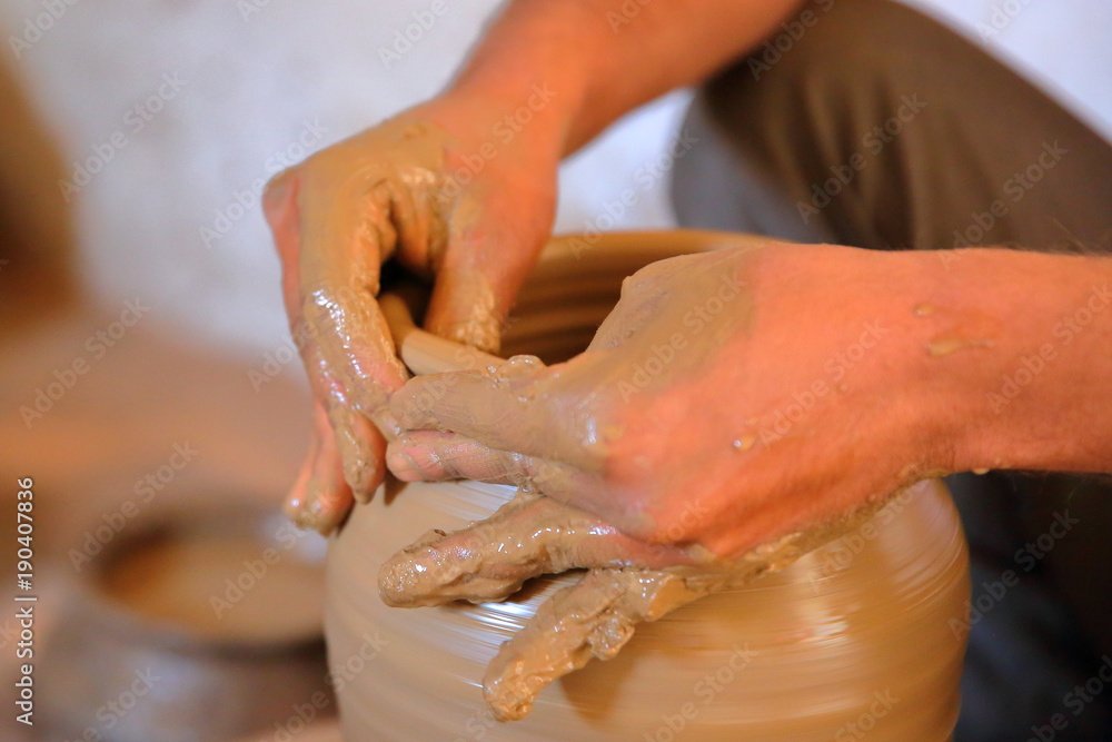 Close-up on the hands of a Potter at work in a village close to Bundi, Rajasthan, India