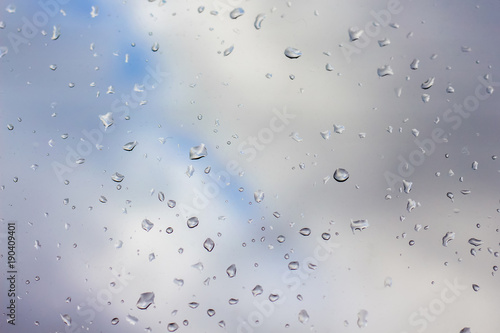 drops of rain on clear glass, far away blurred sky