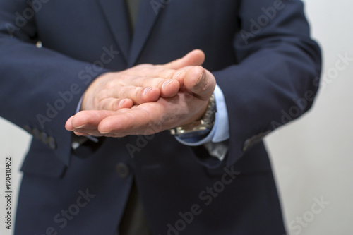 Businessman rubbing his hands together.