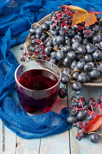 Group of fresh  grape  and juice on wooden  background  