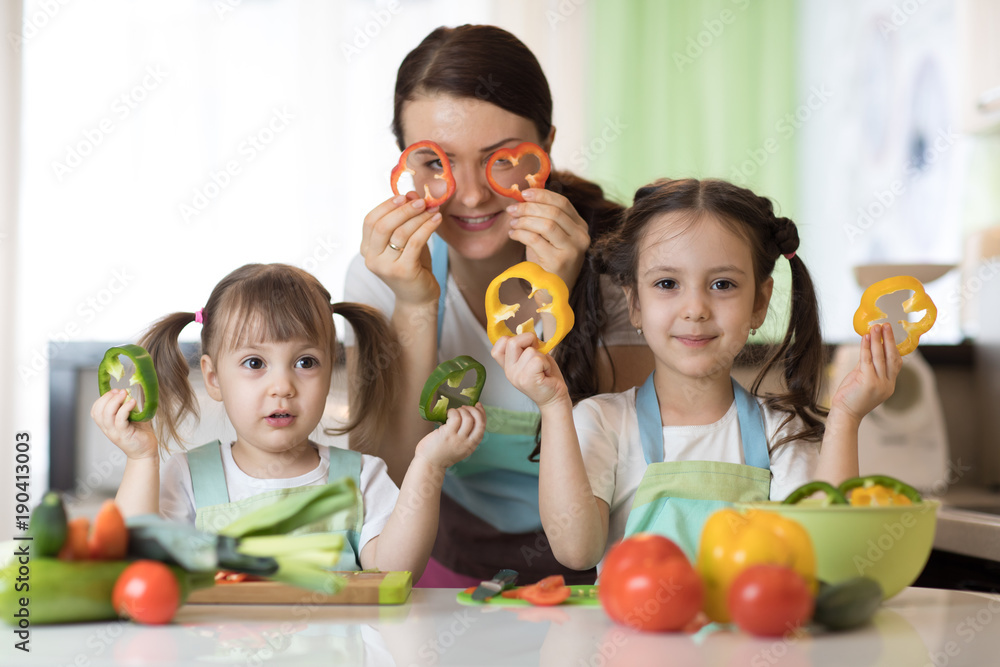 mother and children preparing healthy food and having fun mother and children preparing healthy food and having fun