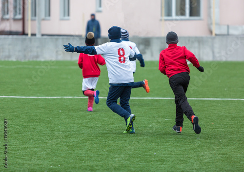 kids play football on stadium at winter. active sportlife concept photo