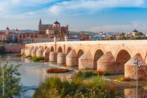 Great Mosque Mezquita - Catedral de Cordoba and Roman bridge across Guadalquivir river in the morning, Cordoba, Andalusia, Spain photo