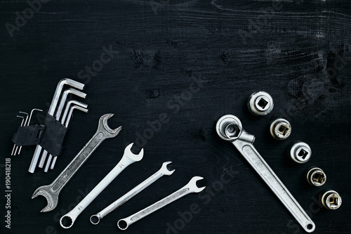 Tools for work or repair auto on black wooden background. Top view