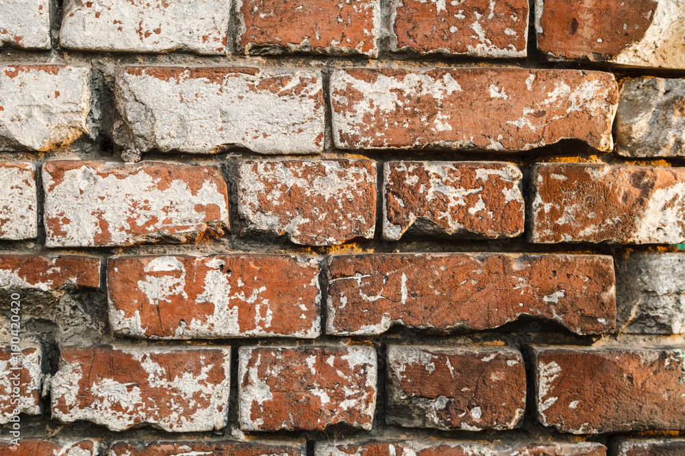 Old brick dirty wall loft style with remains of old paint Old brick dirty wall loft style with remains of old paint