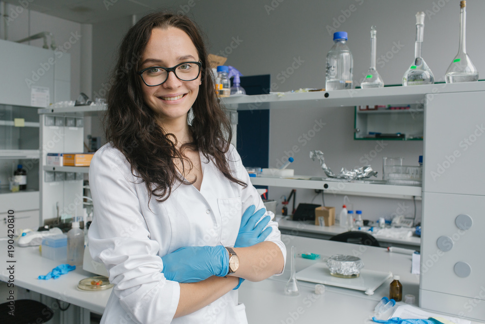 Woman in whites standing in lab Woman in whites standing in lab