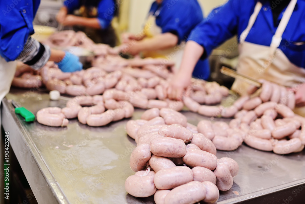 production of boiled sausages and smoked sausage at a meat factory. Food industry production of boiled sausages and smoked sausage at a meat factory. Food industry