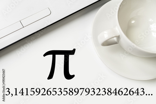 International Pi Day. On a white table a laptop and a cup.
