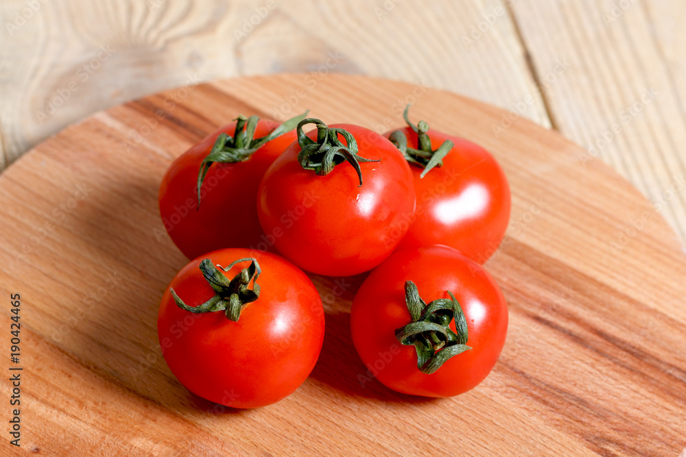ripe red tomatoes on a wooden table ripe red tomatoes on a wooden table