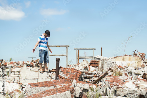 Man observing the destruction of his home.