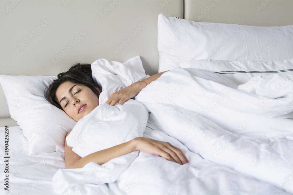 Young Woman Sleeping in White Comfortable Bed Young Woman Sleeping in White Comfortable Bed
