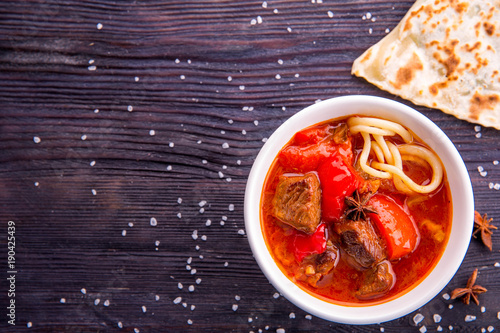 Soup lamian with noodles and pieces of meat photo