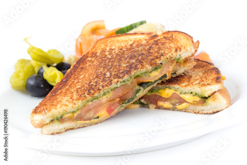 pesto tomato grilled cheese sandwich on white background
