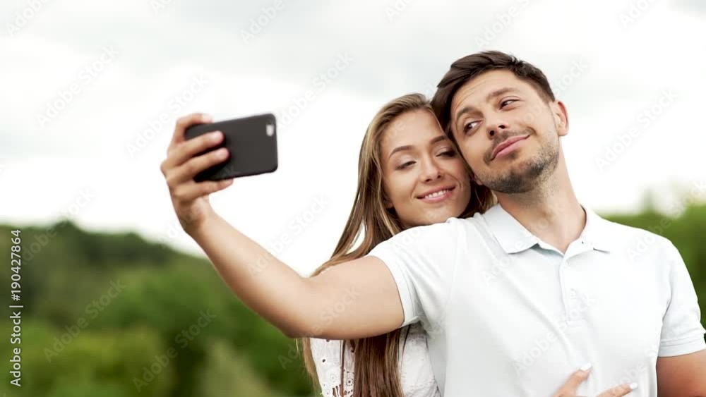 Romantic Happy Couple In Love Taking Photos On Phone In Nature Romantic Happy Couple In Love Taking Photos On Phone In Nature