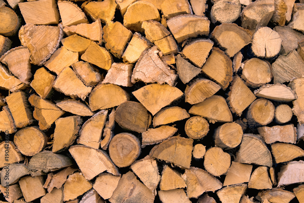 Material for heating the house. Preparation of firewood for the winter. background of firewood. A pile of firewood. Material for heating the house. Preparation of firewood for the winter. background of firewood. A pile of firewood.