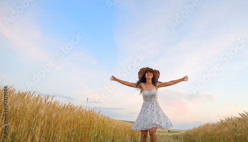 Woman in wheat field enjoying, freedom concept