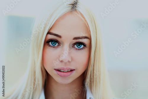 Beautiful woman with long straight blond hair. Fashion model posing at studio.