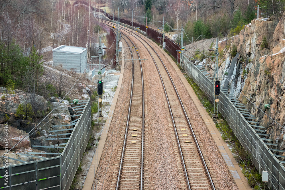 View from above of double railroad tracks in a mountain and forest evironment. View from above of double railroad tracks in a mountain and forest evironment.