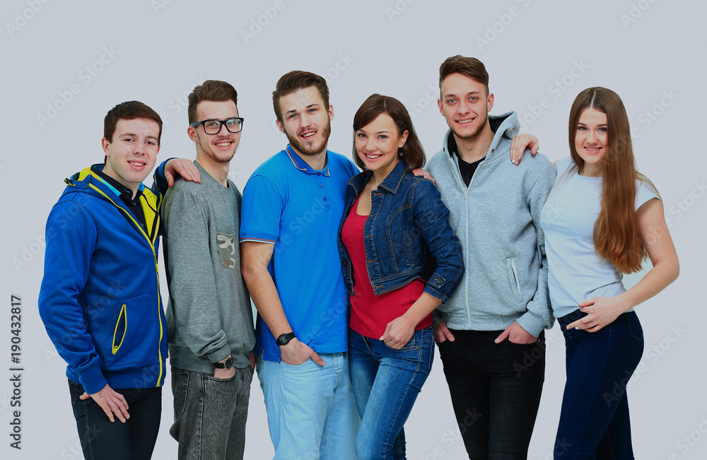 group of smiling friends staying together and looking at camera isolated on white background.