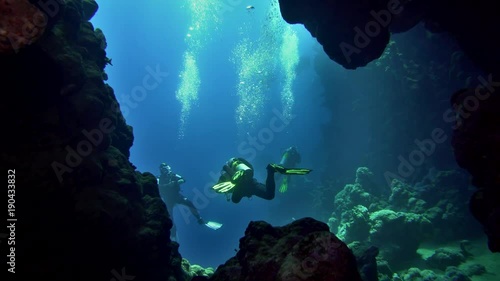 cave diving underwater scuba divers exploring cave dive photo