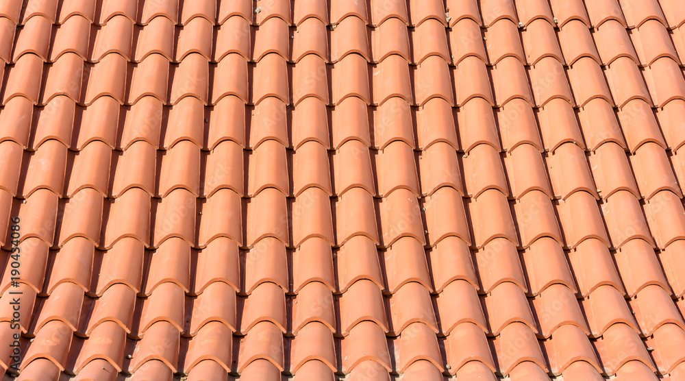 Texture of orange roof tiles of a new roof