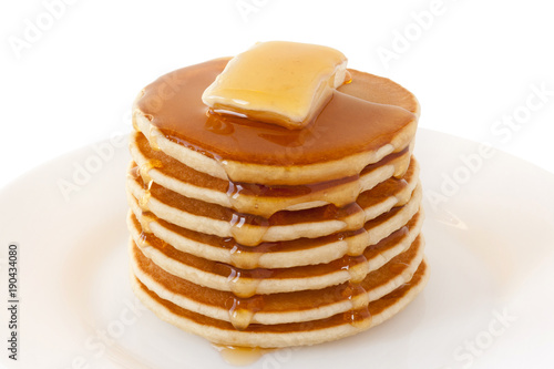 Pancakes Stack with Butter and Maple Syrup isolated on a white background. Shrove Tuesday. Mardi Gras. Pancakes Day. Food. Family Breakfast. Brunch. Dessert. Snacks. Sweets.