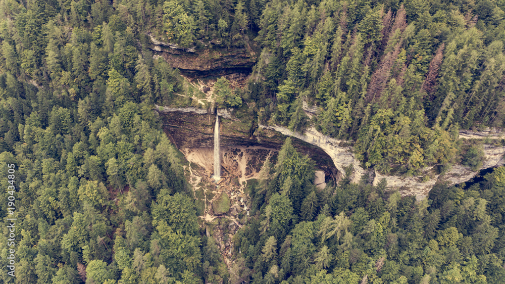 Aerial view of double water fall in a forest.