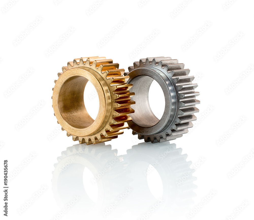 Sets of gears, cogwheels made of steel and brass isolated on white background with shadow reflection. Spur gears isolated on white background with shadow reflection. Sets of gears, cogwheels made of steel and brass isolated on white background with shadow reflection. Spur gears isolated on white background with shadow reflection.