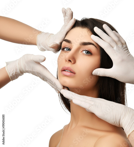 Beautiful young woman face plastic surgery and doctor hands in medical gloves