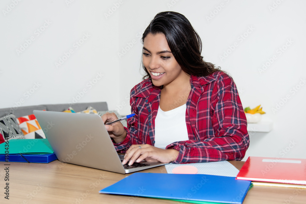 Latin american female student working with laptop Latin american female student working with laptop