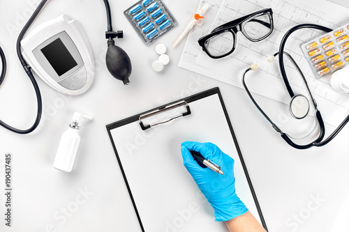 Doctor s table, tools, medical instruments, therapist tonometer, blood pressure, work in hospital on white background flat lay photo