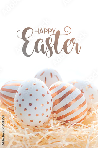 Happy easter postcard banner. Golden Easter eggs in straw nest on white background.
