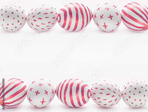 Red Easter eggs row frame on wooden white background.