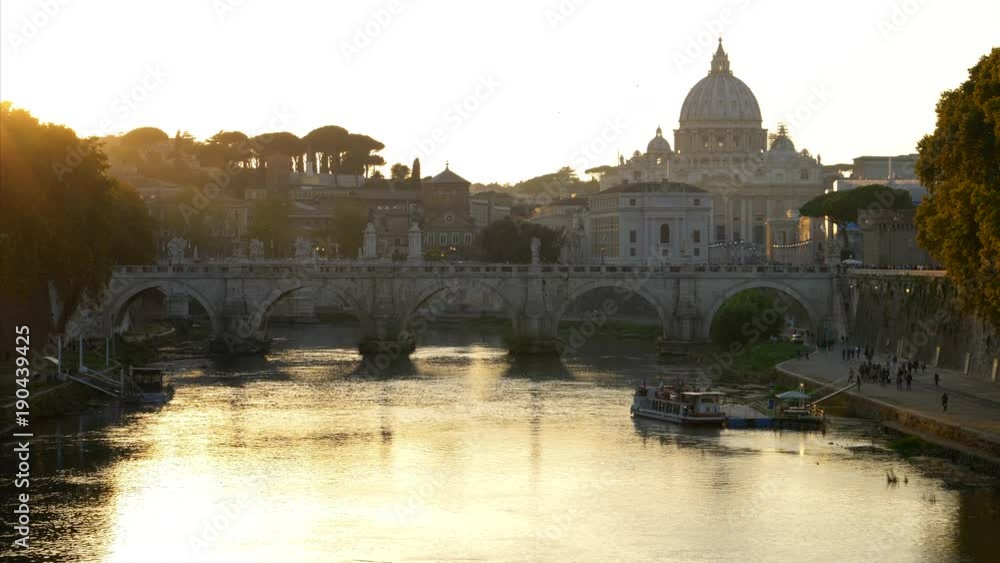 St Peter's Basilica in Vatican City along the Tiber River in Rome, Italy at sunset St Peter's Basilica in Vatican City along the Tiber River in Rome, Italy at sunset