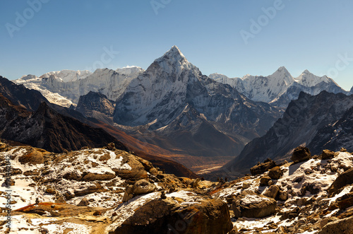 Ama Dablam mountain. Sun illuminates slopes. Himalayan mountains, Nepal.