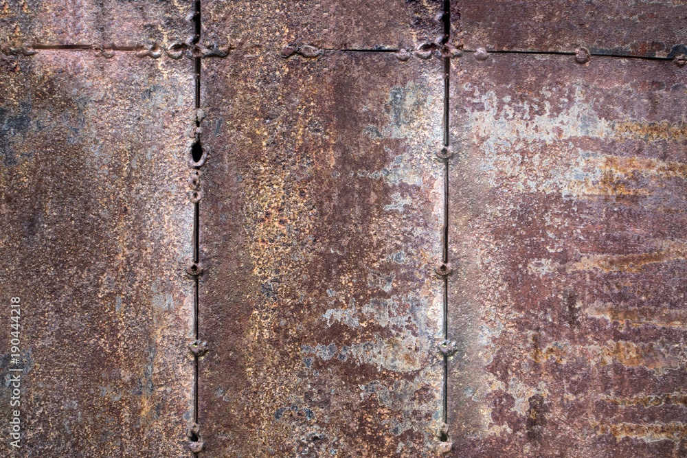 Fototapeta premium Worn dark brown rusty metal texture background. the concept of three columns. abstraction