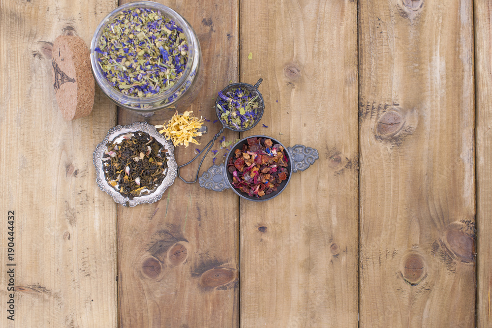 Dried herbs and flowers for tea. Wooden background and free space for text or cards. Dried herbs and flowers for tea. Wooden background and free space for text or cards.
