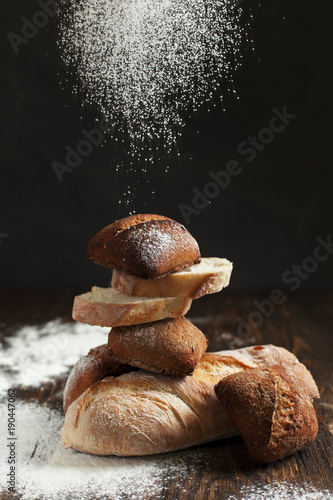 freshly baked bread on a wooden table on a dark background