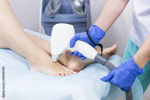 The process of laser depilation of female limbs in the beauty salon