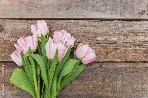 Bouquet of pink tulips over shabby wooden table. Spring greeting card happy mother day copy space
