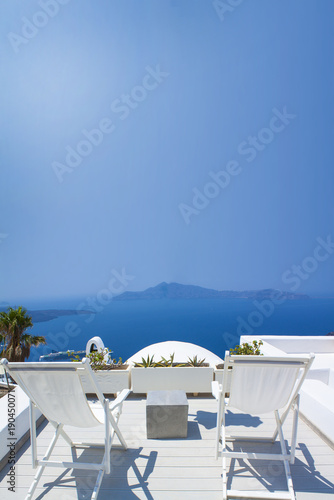 Sunbeds on the terrace of hotel. Santorini island  Greece. Beautiful summer landscape with sea view