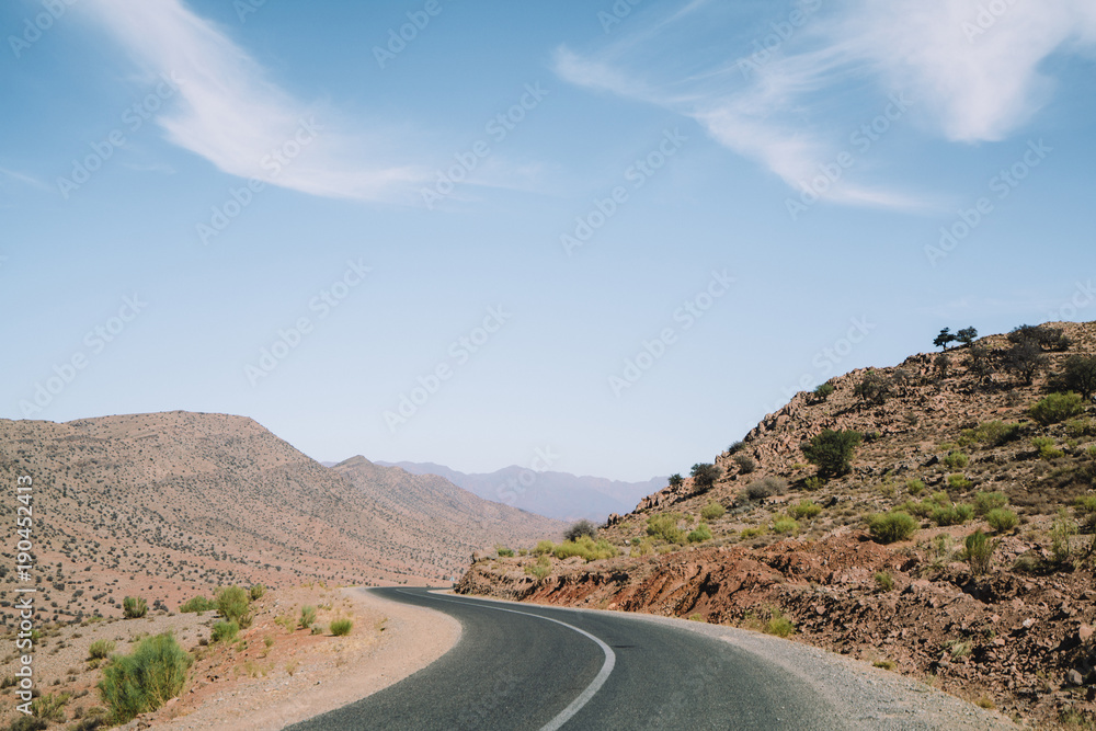 Scenic view of country road amidst mountains against sky Scenic view of country road amidst mountains against sky