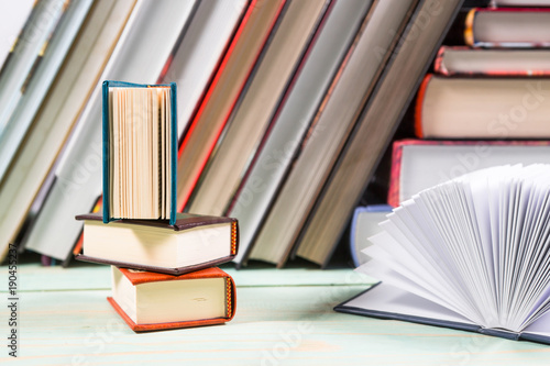 Pile of various books on wooden background