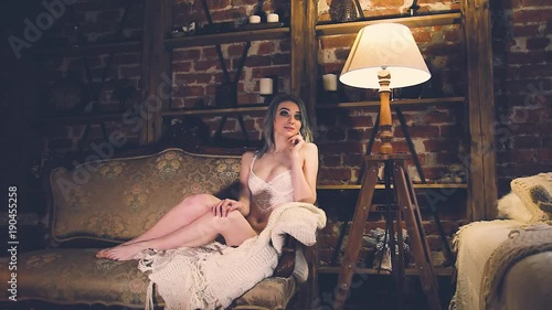 beautiful girl in underwear in the room with retro things and red brick walls photo